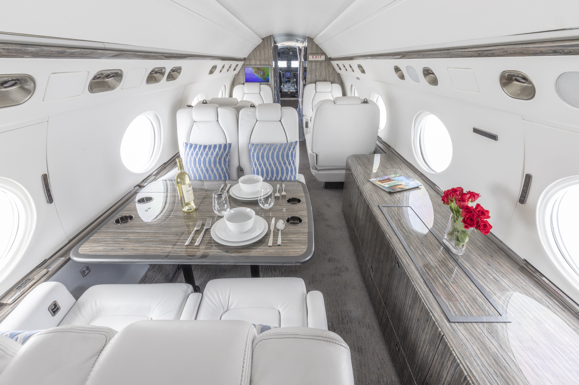 Gulfstream G-V cabin after, seats with a table set for dining