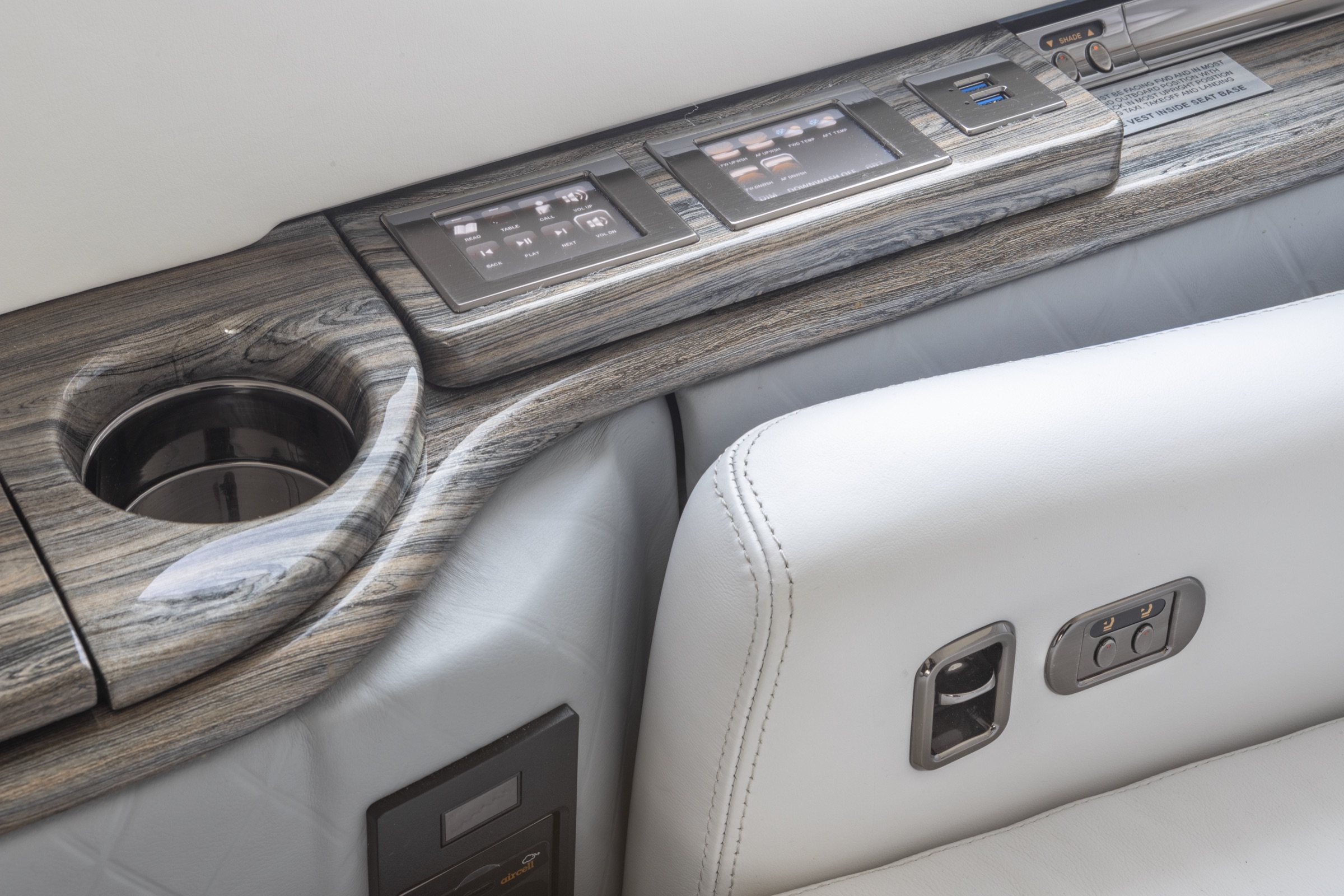 Passenger seat armrest with button controls, close detail