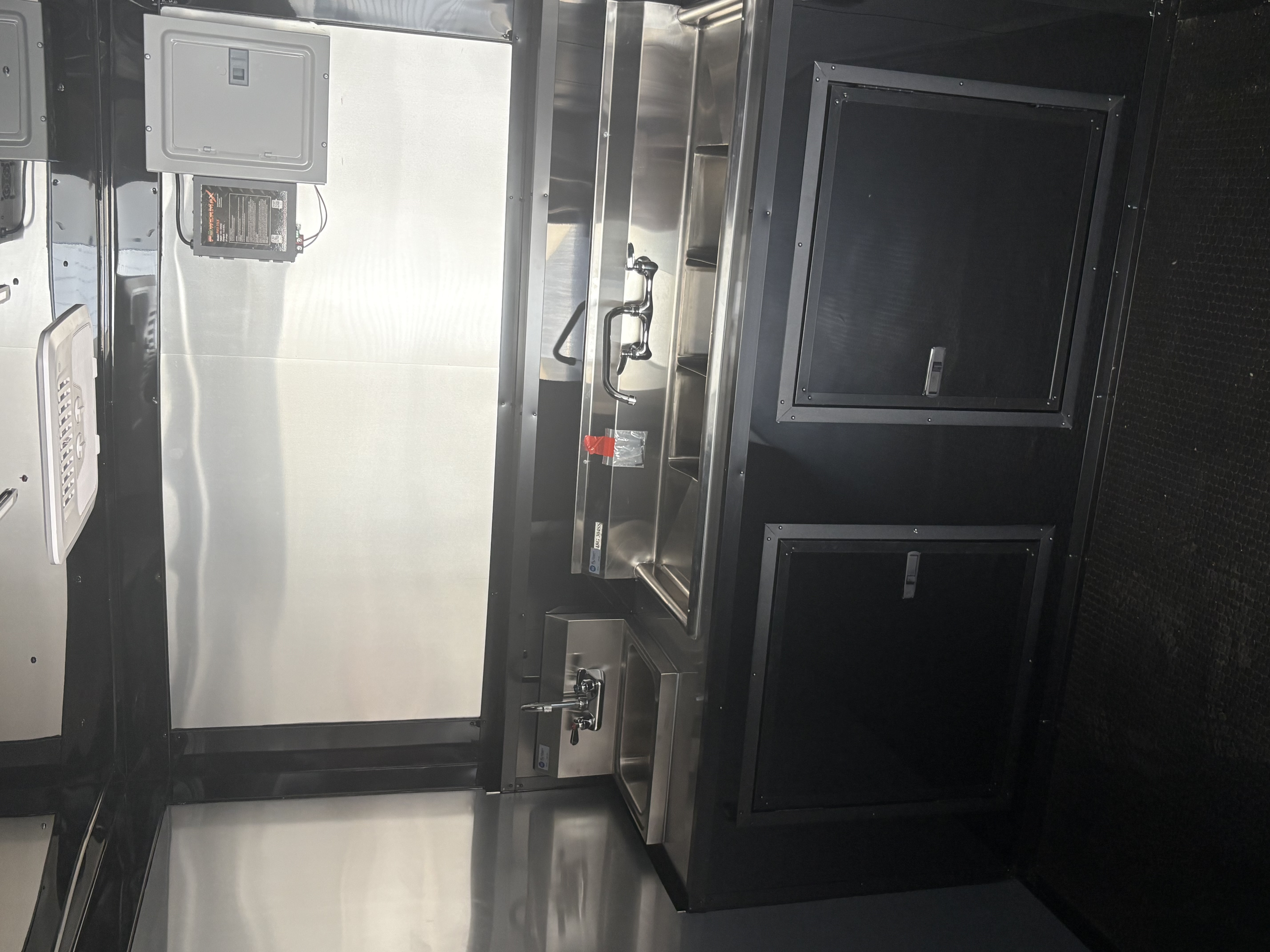 Stainless steel sink and plumbing in a Devil Dog Trailers build