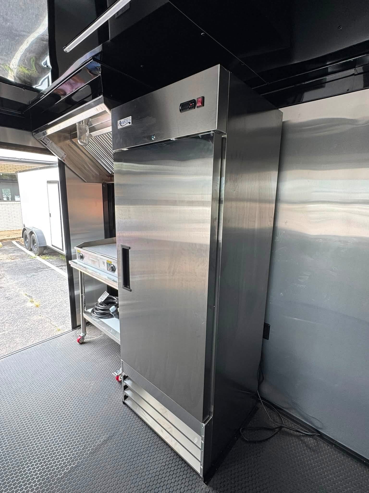 Stainless steel refrigerator installed in a Devil Dog Trailers kitchen trailer