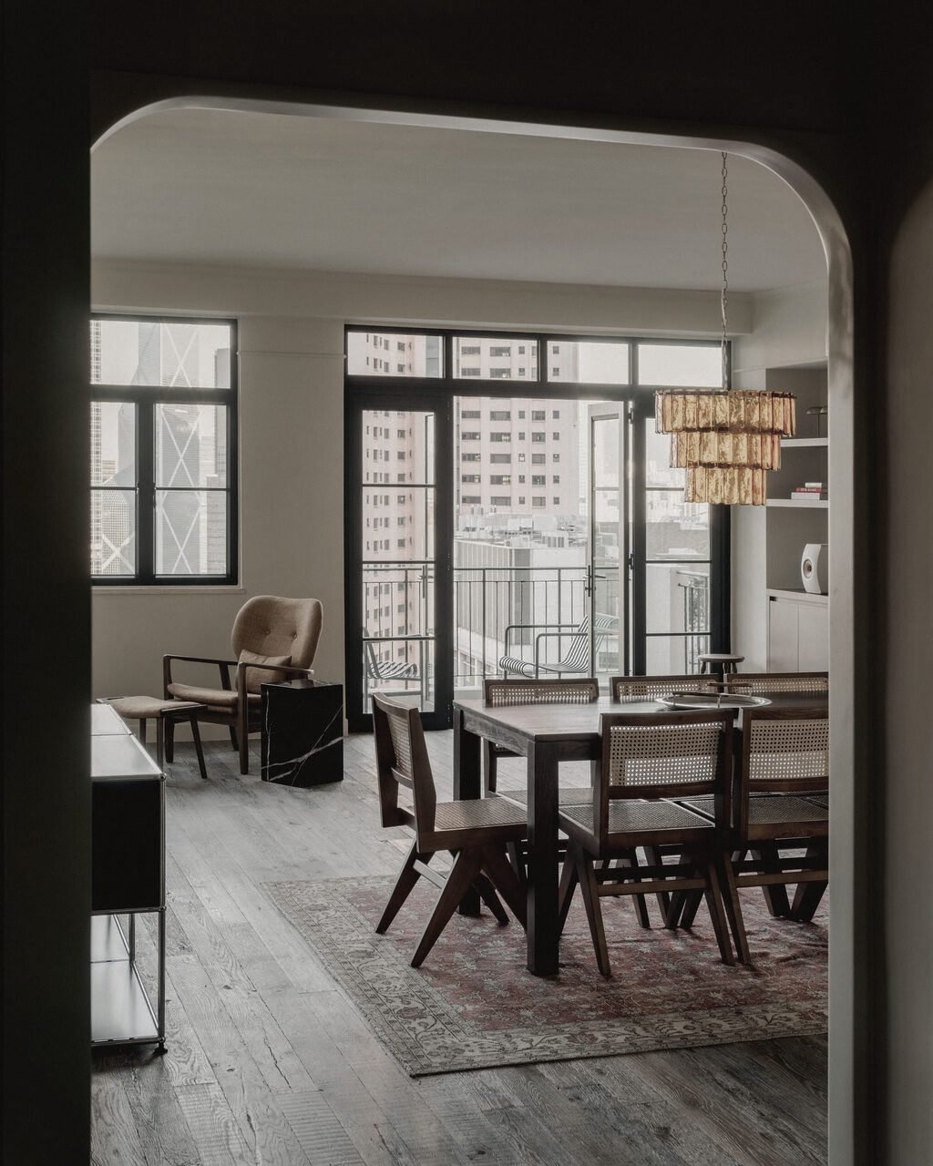 Dining room of the Robinson Road apartment seen through an arched opening