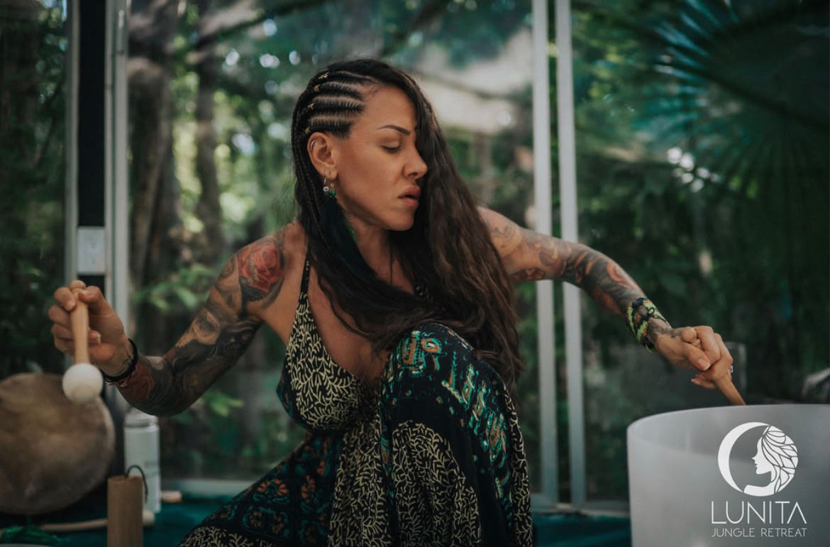 Kat leading a sound healing session with crystal singing bowls