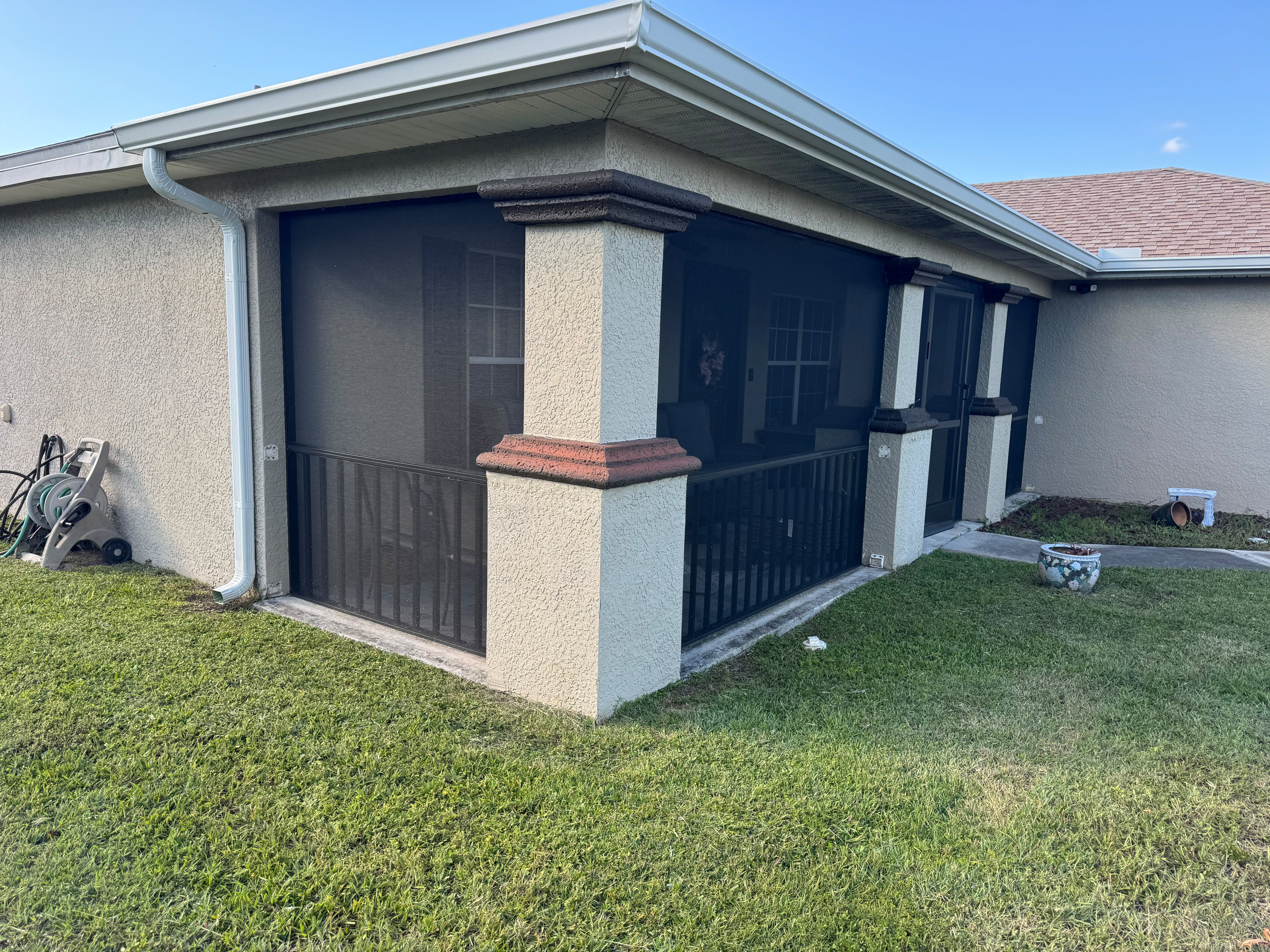 Screen installation around a covered backyard patio