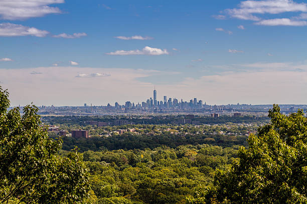 Scenic hillside landscape overlooking a city skyline with panoramic views, greenery, and natural outdoor surroundings.