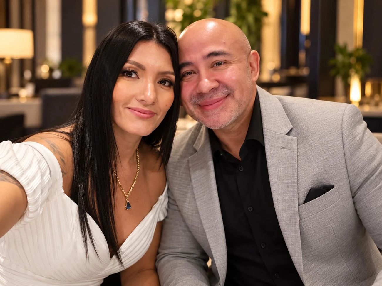 Hector and his wife smiling at dinner