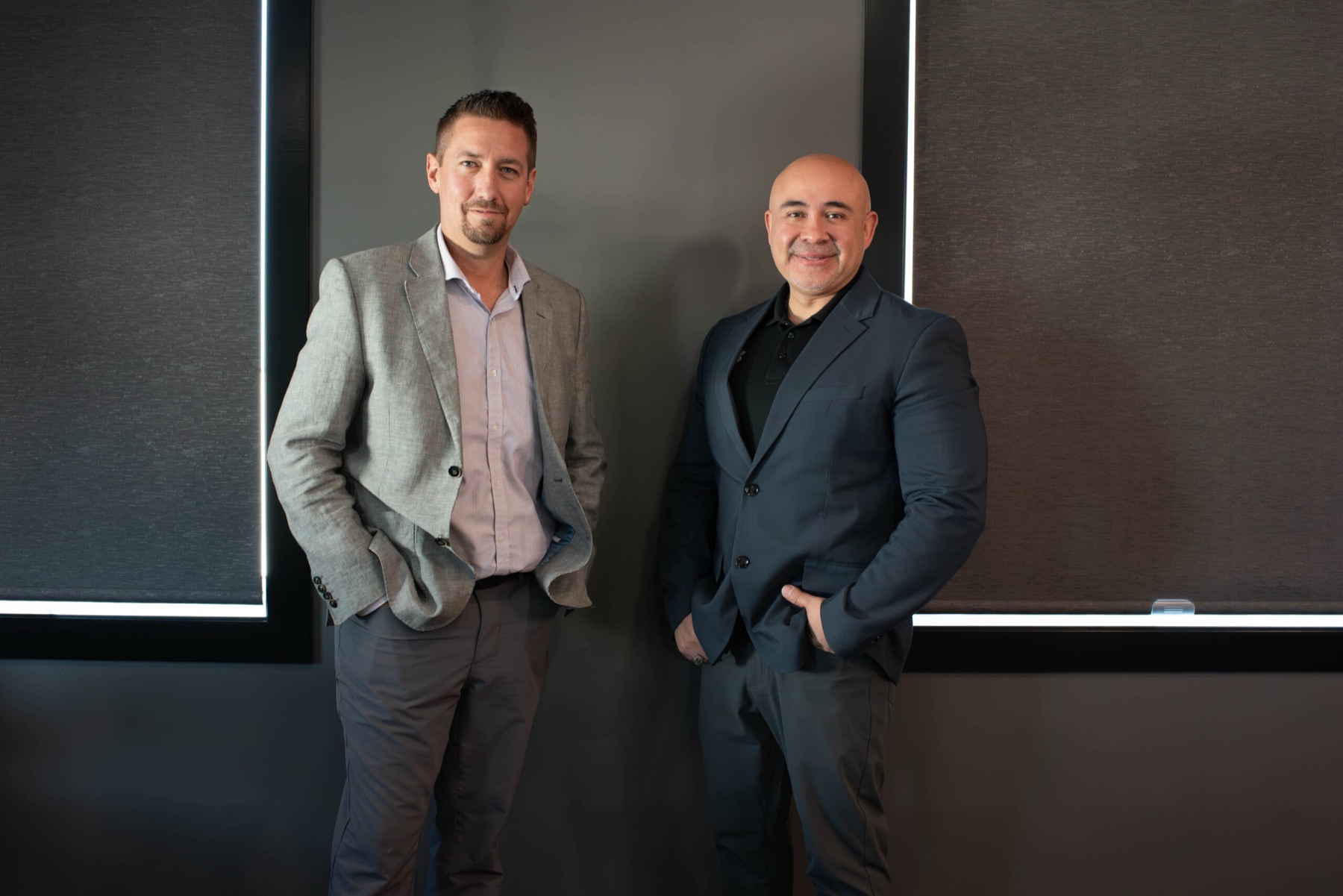 Hector Alvarado and Willy Schmidt standing together in an office