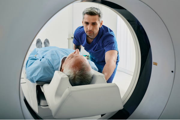Doctor explaining lung cancer screening with CT scan to a former smoker aged 50–80 for early detection and prevention