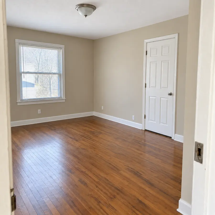 The same rental room freshly painted with clean trim and floors, ready for the next tenant