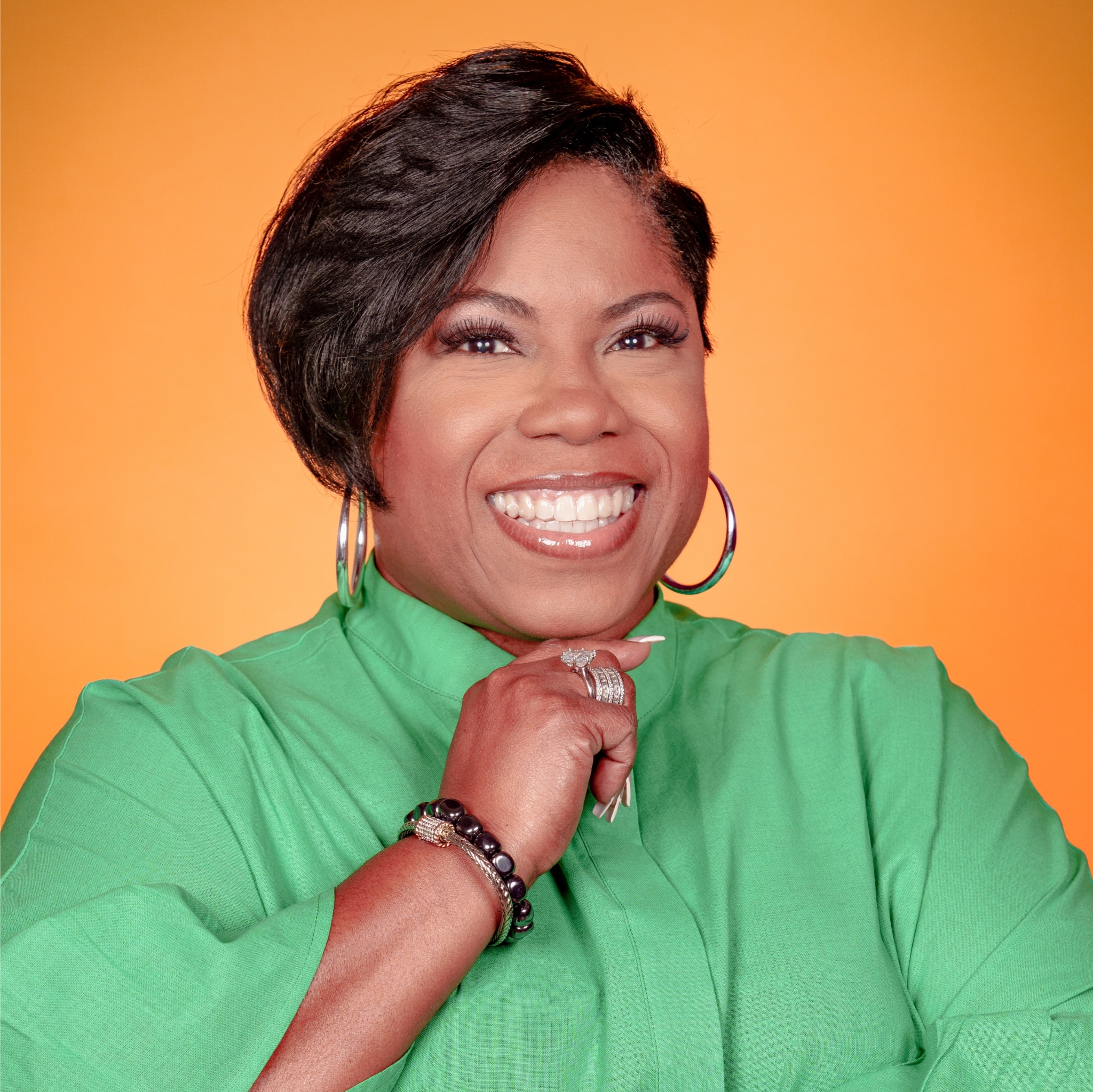 Frances GoMillion wearing emerald green shirt smiling warmly