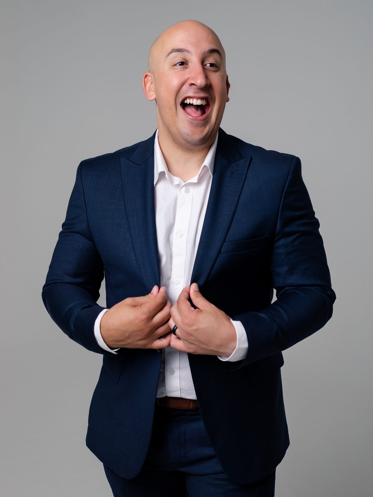 Dalin Oliver laughing in a navy suit