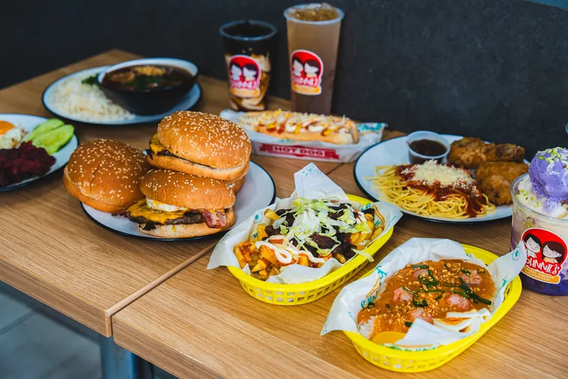 Filipino catering spread from Johnnie's: burgers, fried chicken with spaghetti, palabok, silog plates, loaded fries and drinks