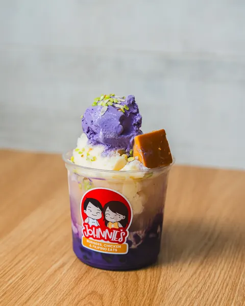 Halo-halo topped with ube ice cream and leche flan in a Johnnie's cup