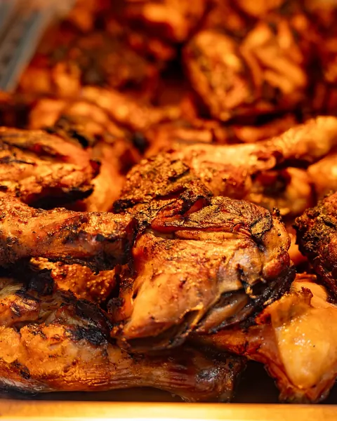 Golden chicken pieces glistening under a warm lamp at Johnnie's Windsor