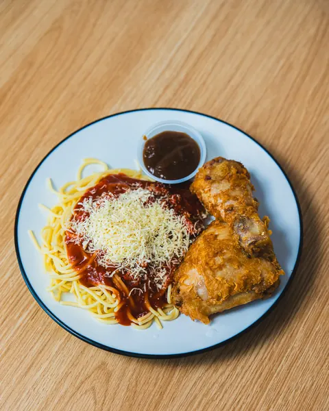 Spaghetti Special with two pieces of crispy OG Fried Chicken, sweet Filipino spaghetti, cheese and gravy