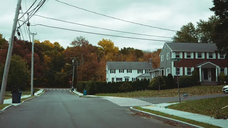 Colonial homes on a tree-lined corner in autumn