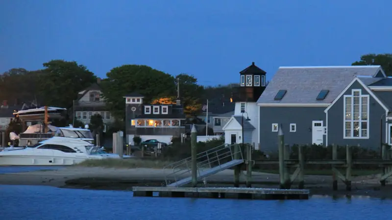 Waterfront homes and boats along a canal at dusk