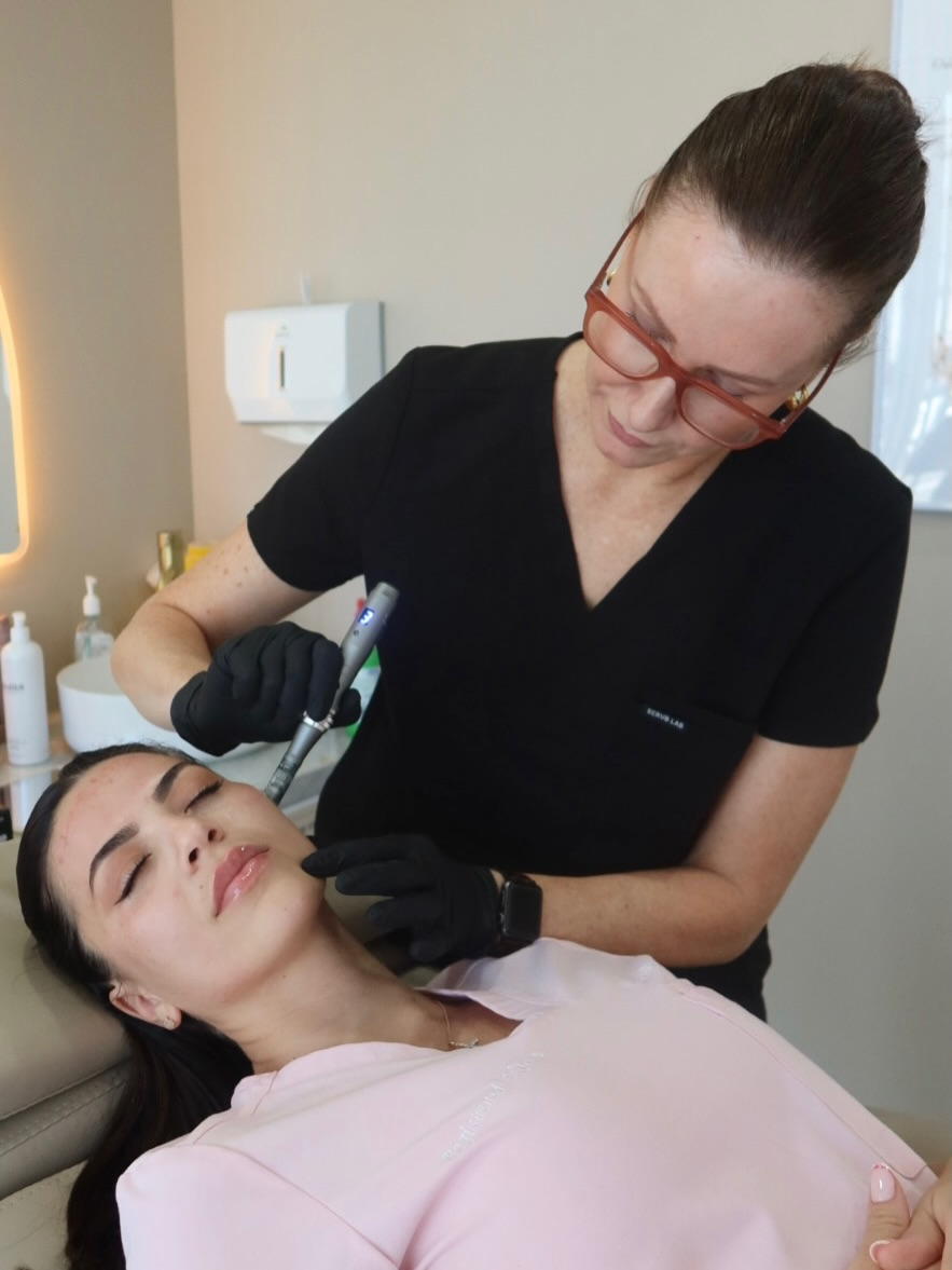 Skye mapping and sketching a personalised brow shape onto a client during a consultation