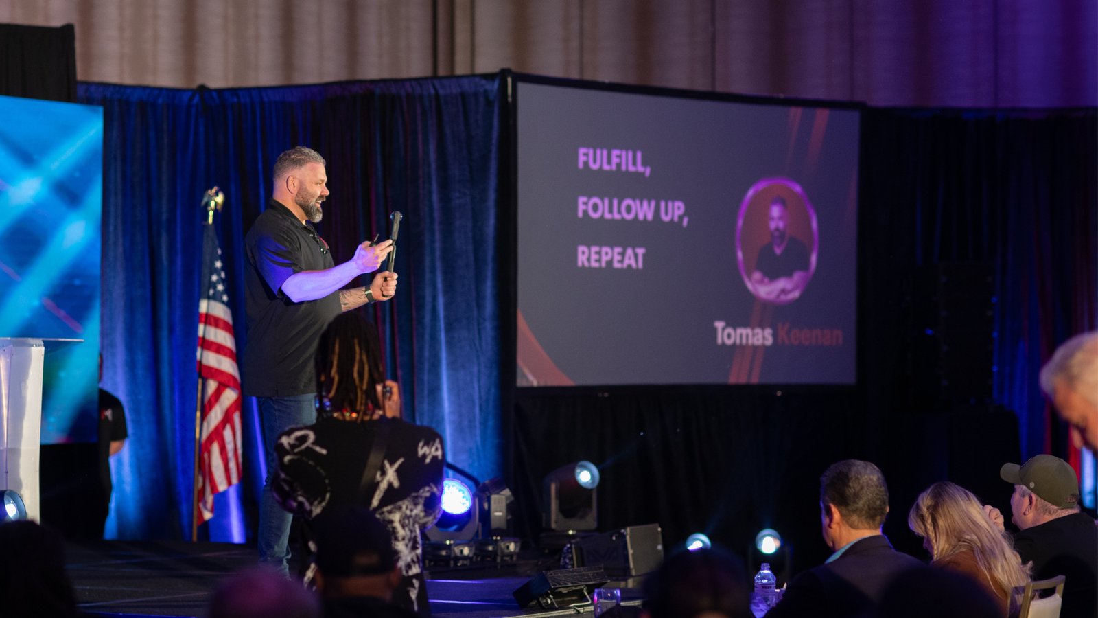Tomas Keenan speaking on stage