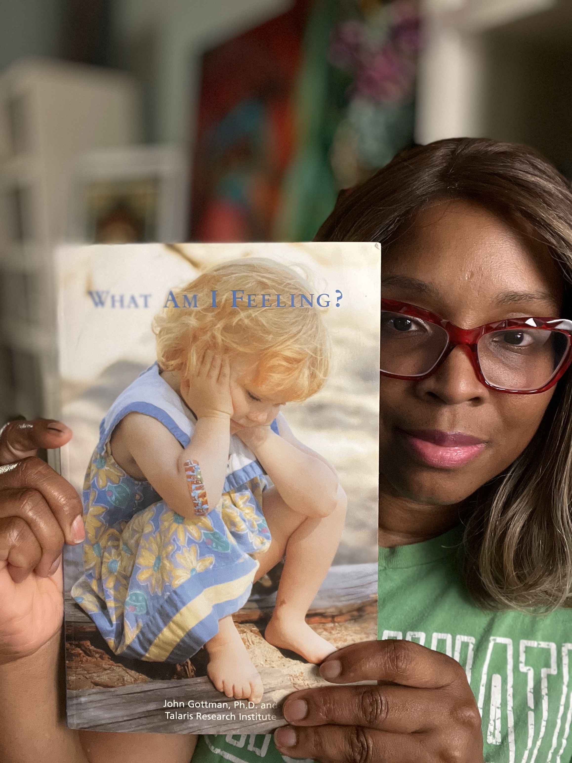 Dr. Stacey holding John Gottman's book What Am I Feeling