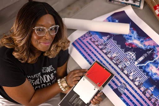 Dr. Stacey Denise with artwork