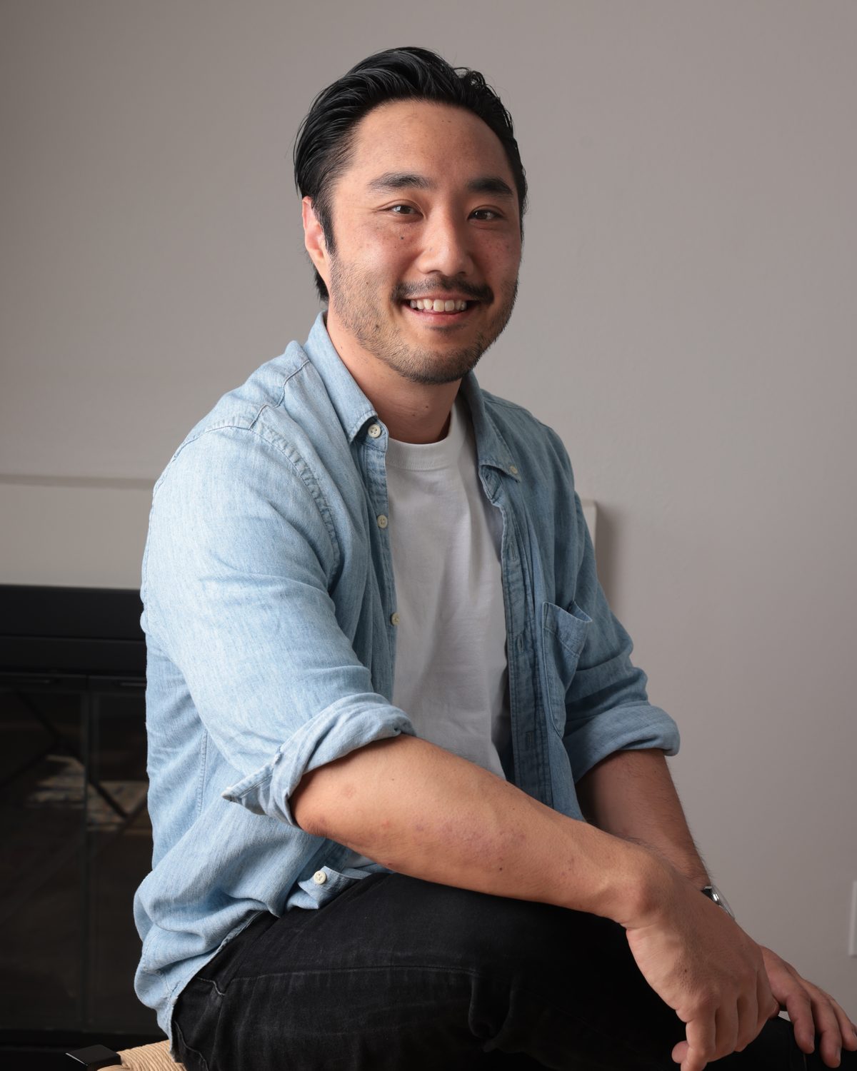 Jeff Kimura, founder of Kimura Worldwide, seated in a chambray shirt, smiling at the camera