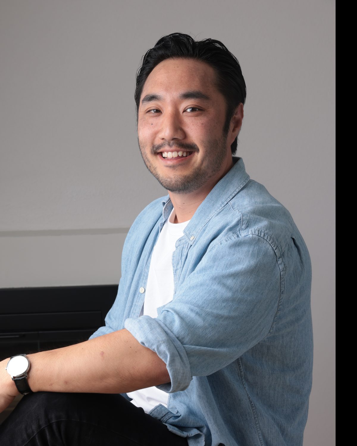 Jeff Kimura, seated, looking at the camera