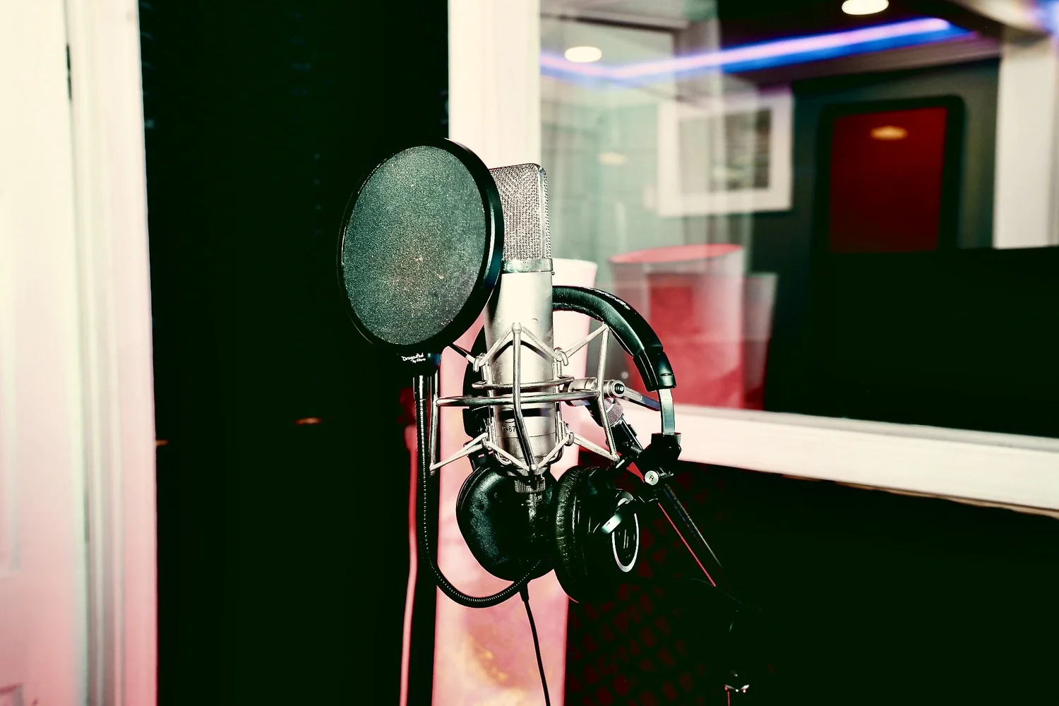 Creator recording vocals in a professional studio booth