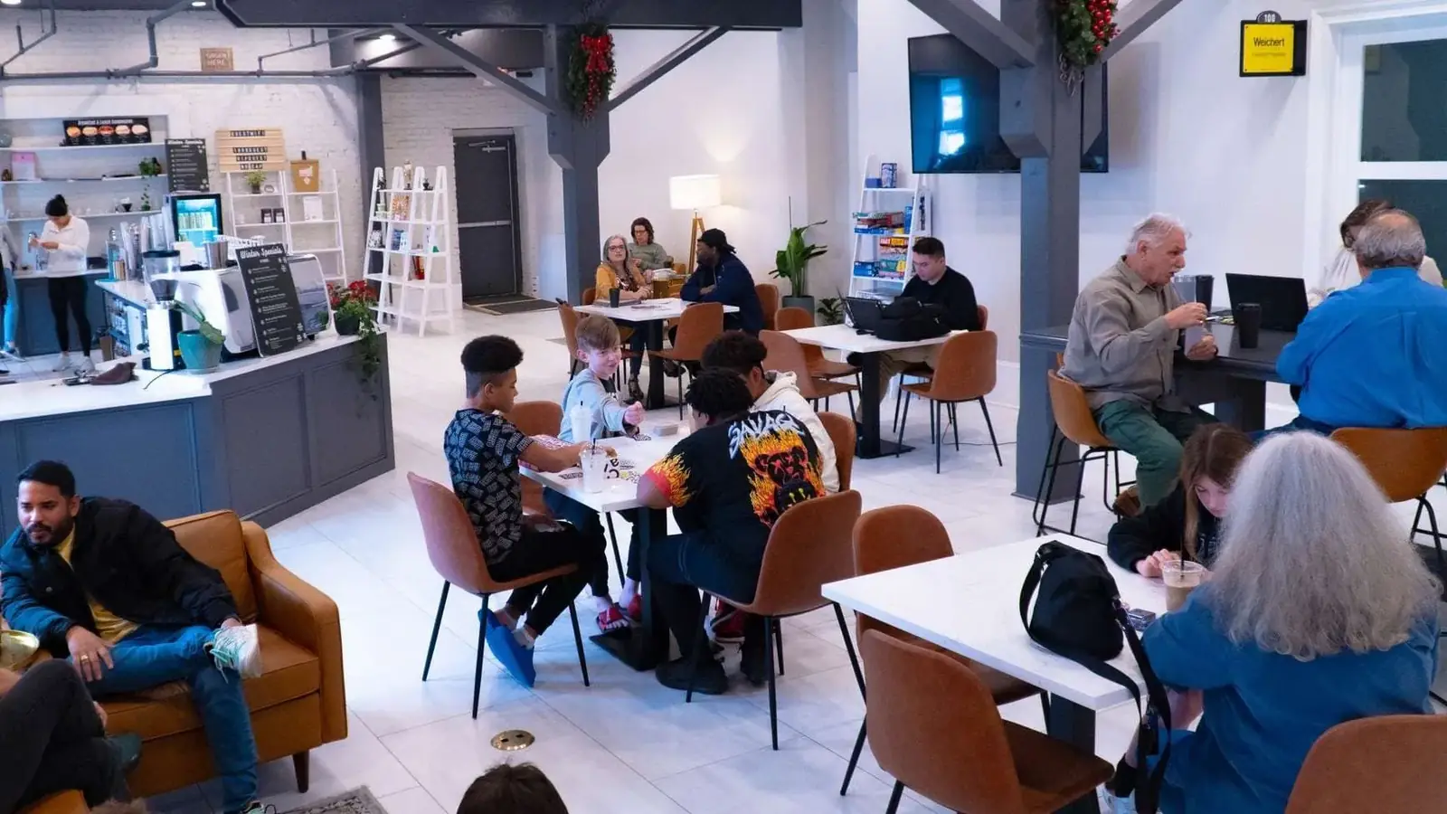 Bright dining area with tables and lounge chairs inside Sirincci Coffee Company