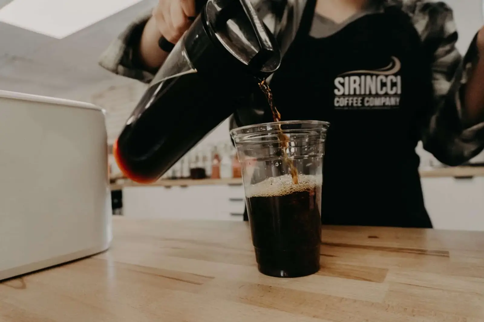 Sirincci Coffee Company barista pouring fresh brewed coffee
