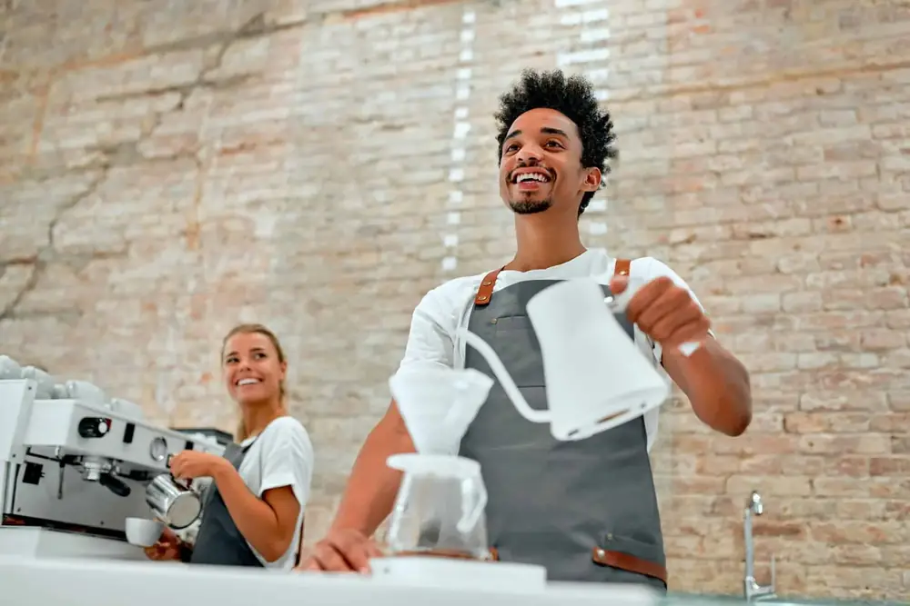 Barista demonstrating a pour-over coffee for a customer