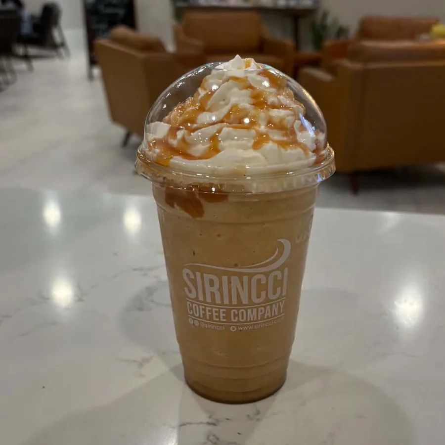 Caramel frappé topped with whipped cream and caramel in a Sirincci Coffee cup