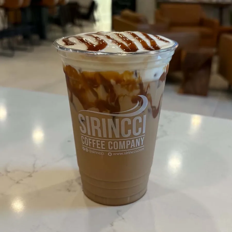 Iced Coco Beach Latte with caramel drizzle and coconut cold foam at Sirincci Coffee