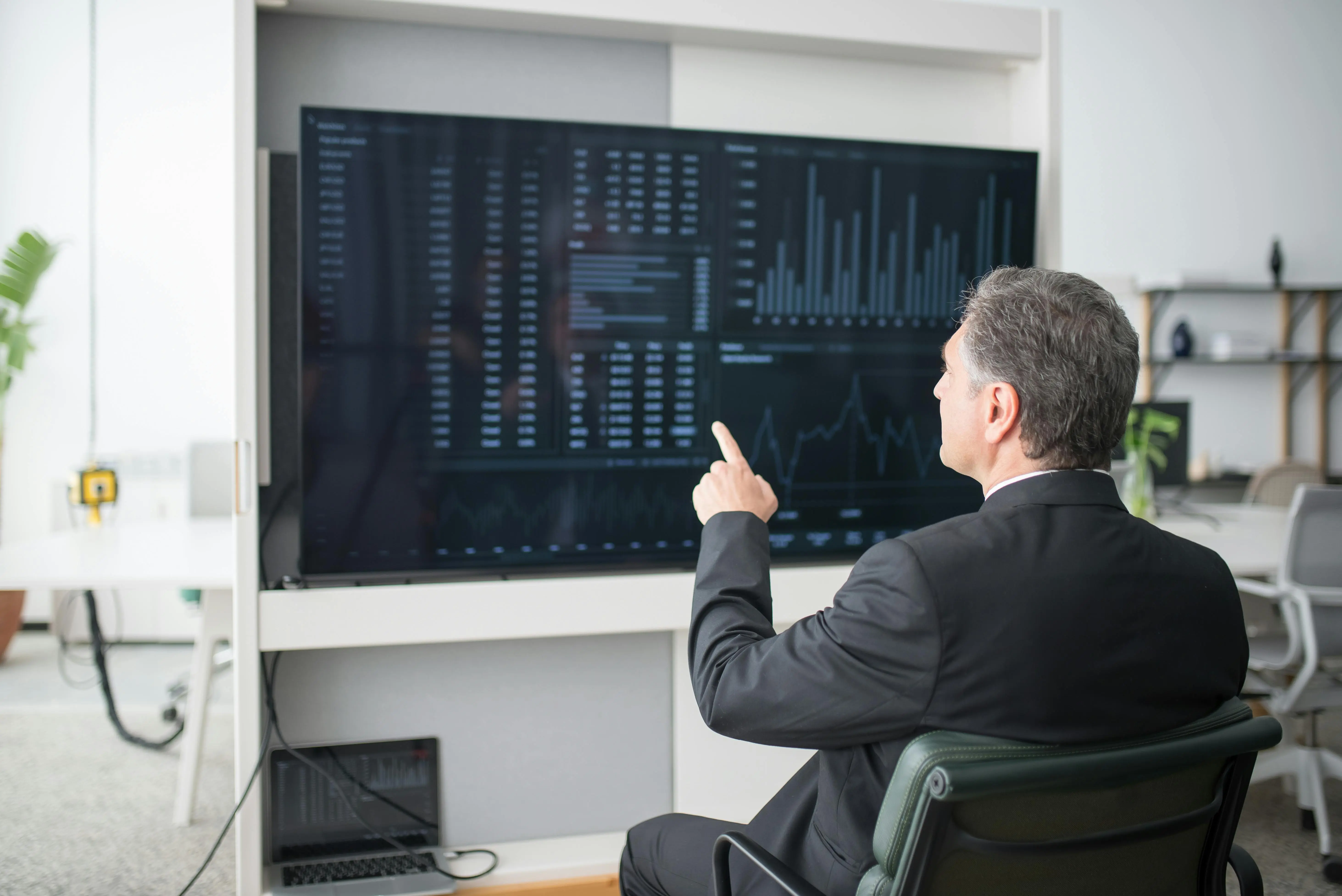 A dark analytics dashboard on a laptop screen displaying performance metrics and session data — the kind of real-time operational visibility that systems create