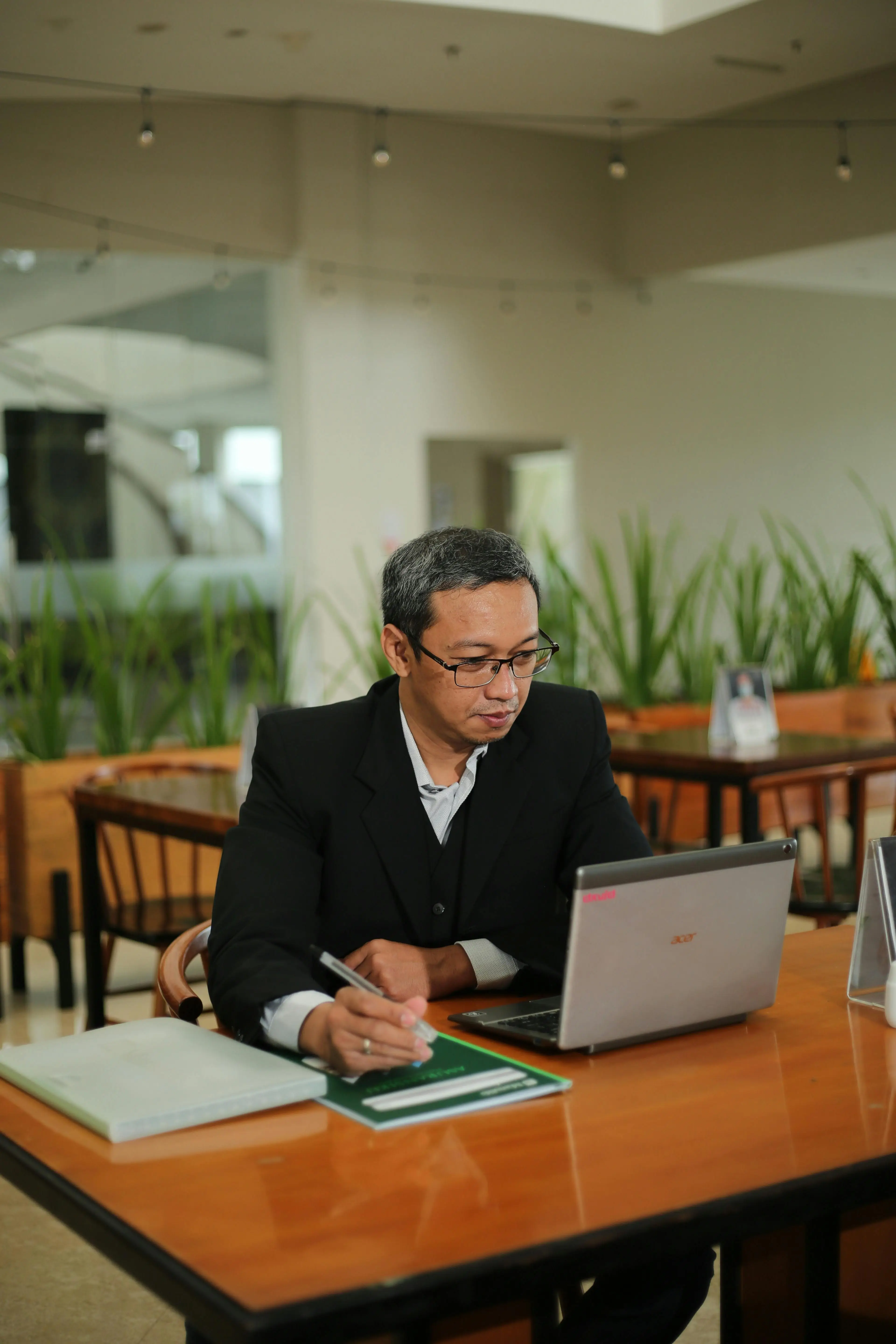 Business consultant reviewing lead pipeline data on a laptop, representing agentic lead scoring and sales follow-up automation for coaches and consultants