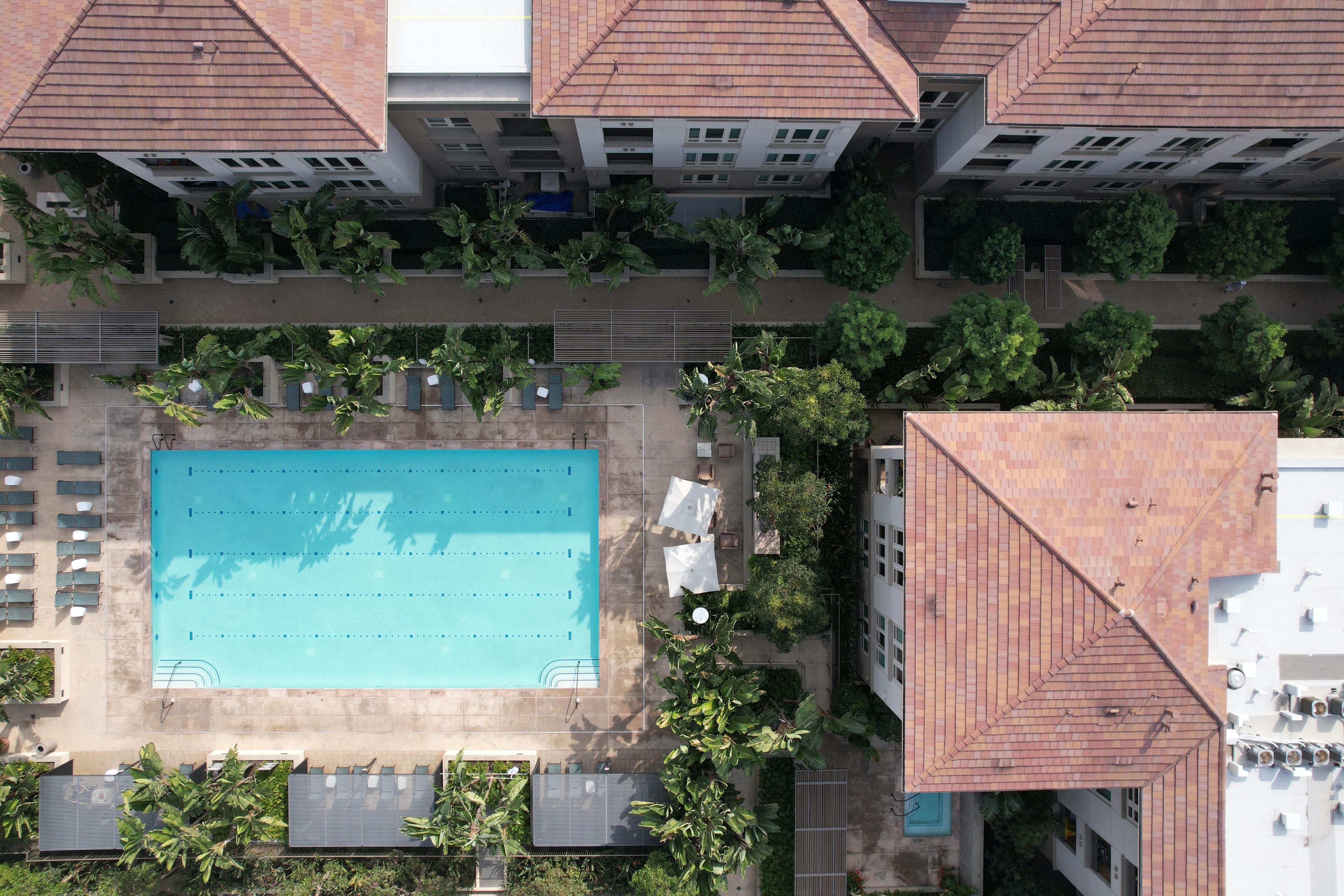 Bird's-eye aerial view of white residential apartment buildings in a dense neighbourhood — representing the kind of multi-family real estate that Canadian entrepreneurs use to build long-term rental income