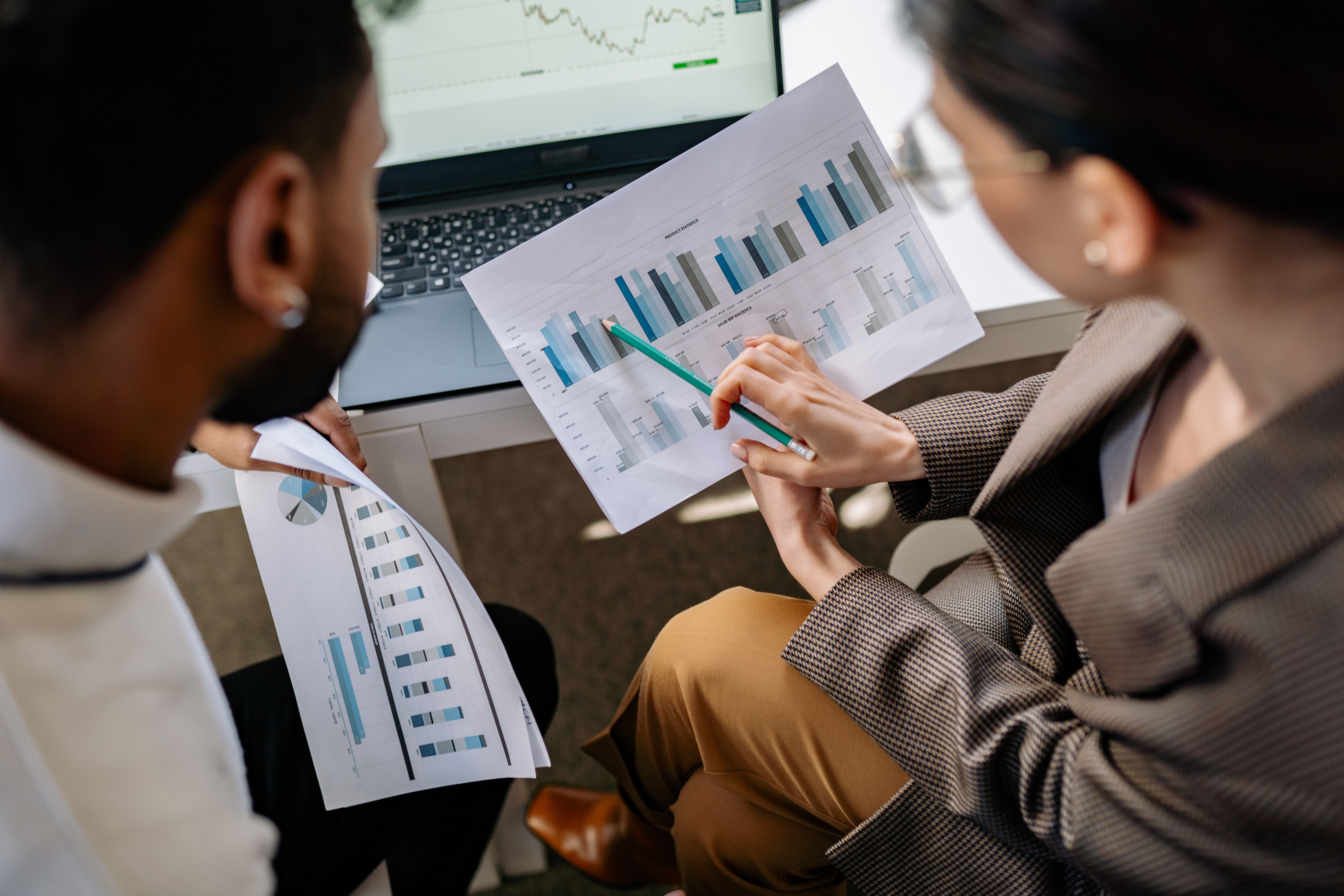 A small business owner reviews an AI-generated lead qualification summary on a laptop, showing flagged prospects and automated follow-up tasks completed overnight by an agentic workflow
