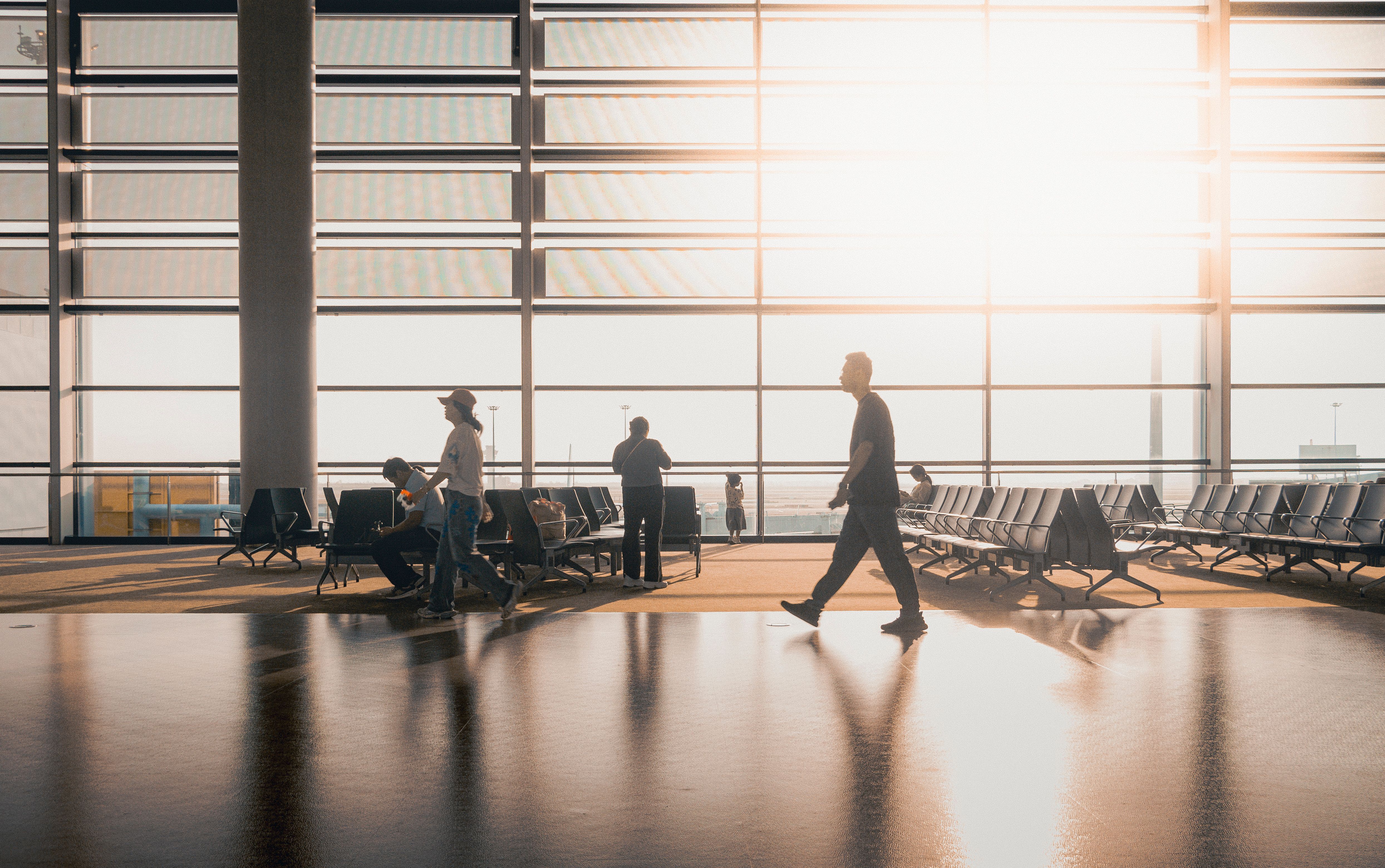 Indian family arriving at a Canadian airport with immigration documents — permanent residency landing after an Express Entry PR approval