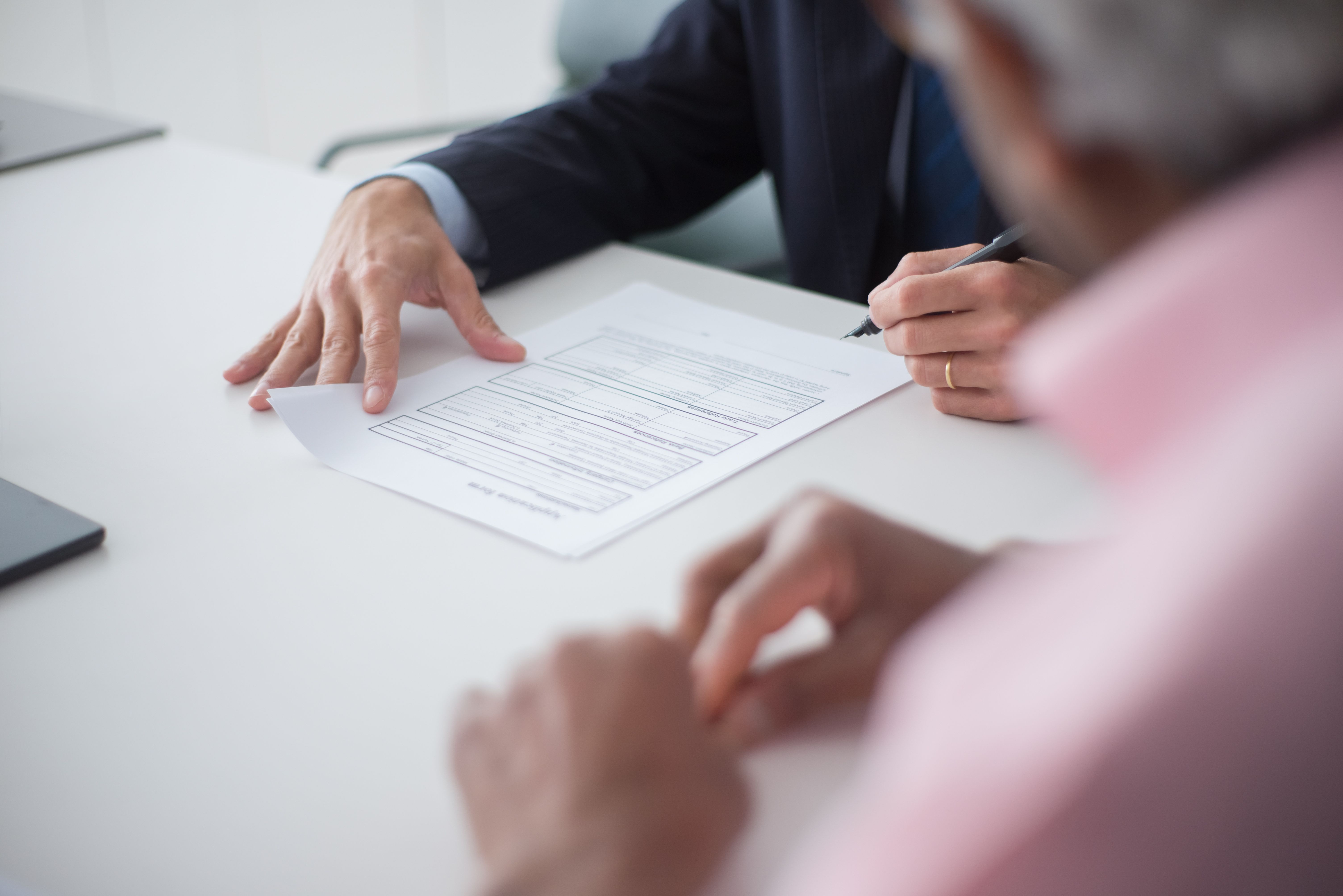 Immigration consultant reviewing Canadian permanent residency application documents with an Indian professional client in a Mississauga office