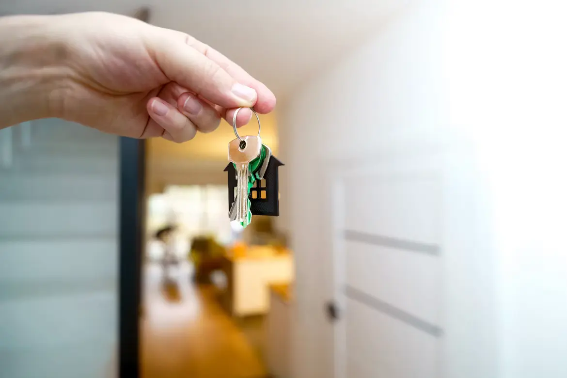Indian family receiving house keys from a real estate agent in Mississauga — newcomer first-time home buyers celebrating their purchase in 2026