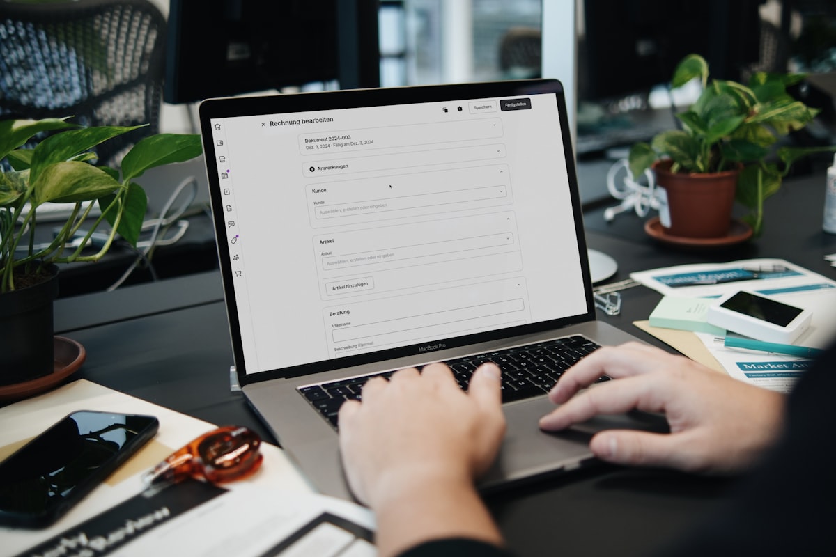 Canadian small business owner setting up automated invoicing software on a laptop at a desk