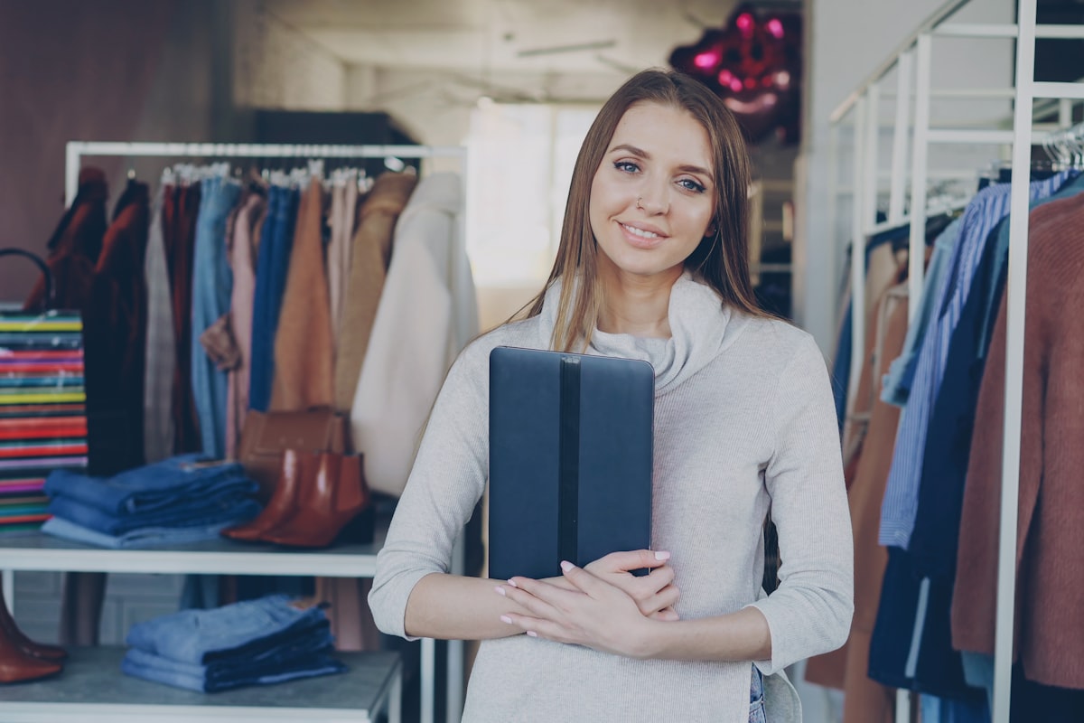 Canadian retail store owner using an AI chatbot dashboard on a tablet to manage customer service