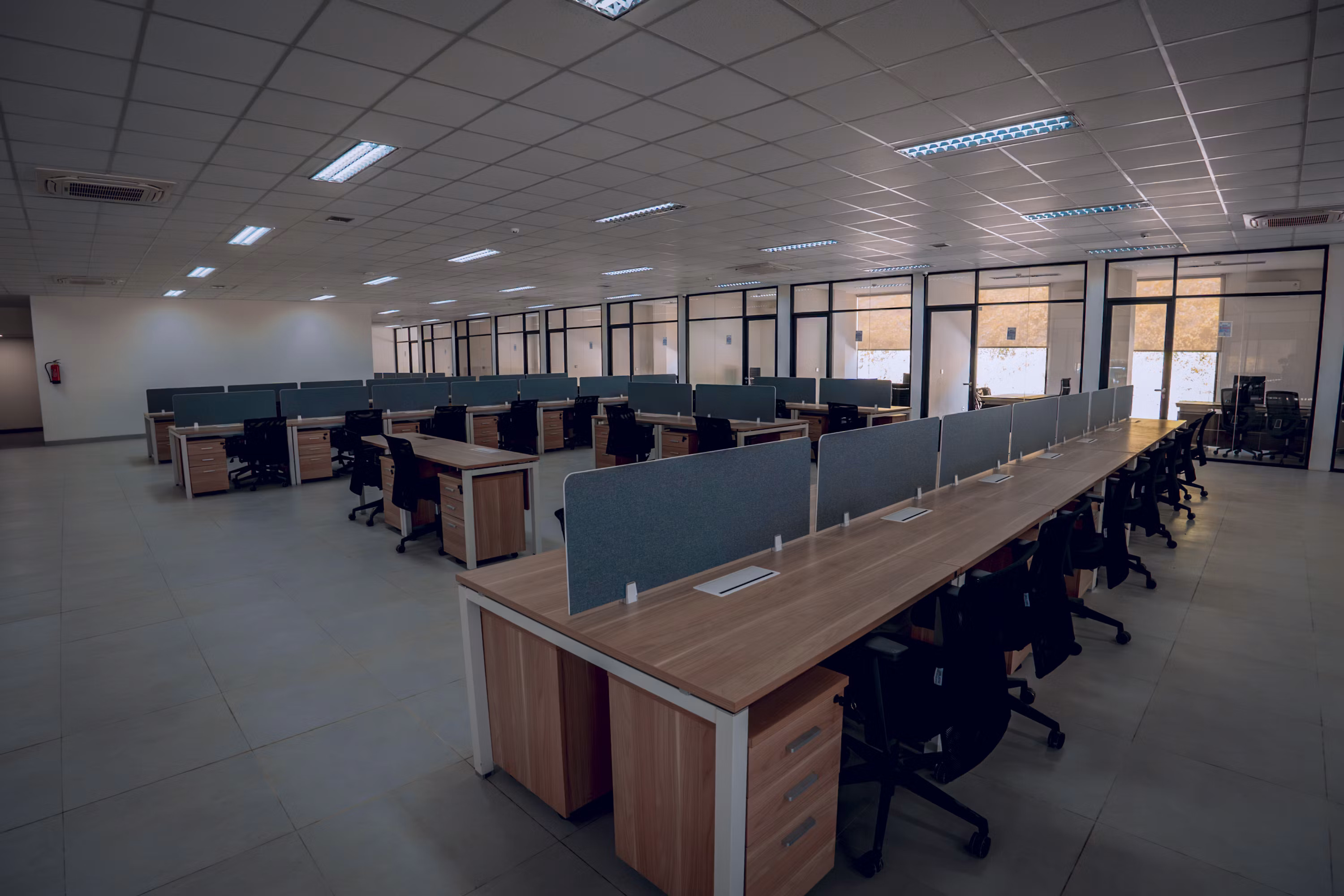 An empty office space with desks and chairs, representing an AI startup that has shut down and left its small business customers stranded