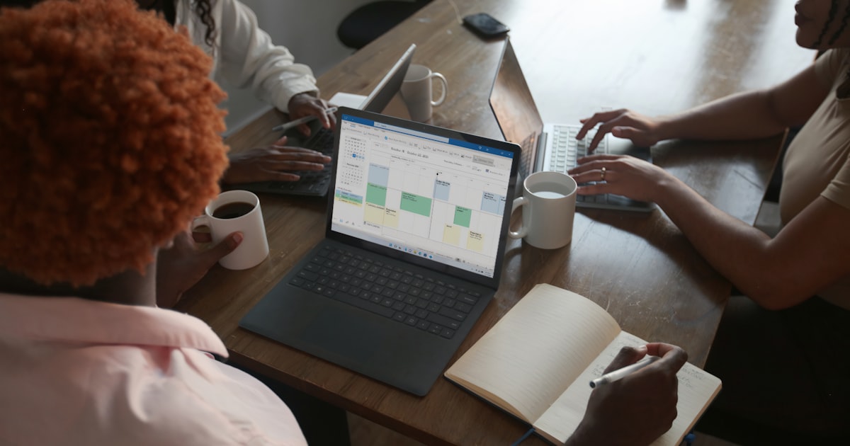 A small business team maps out a strategy on a whiteboard during a planning meeting