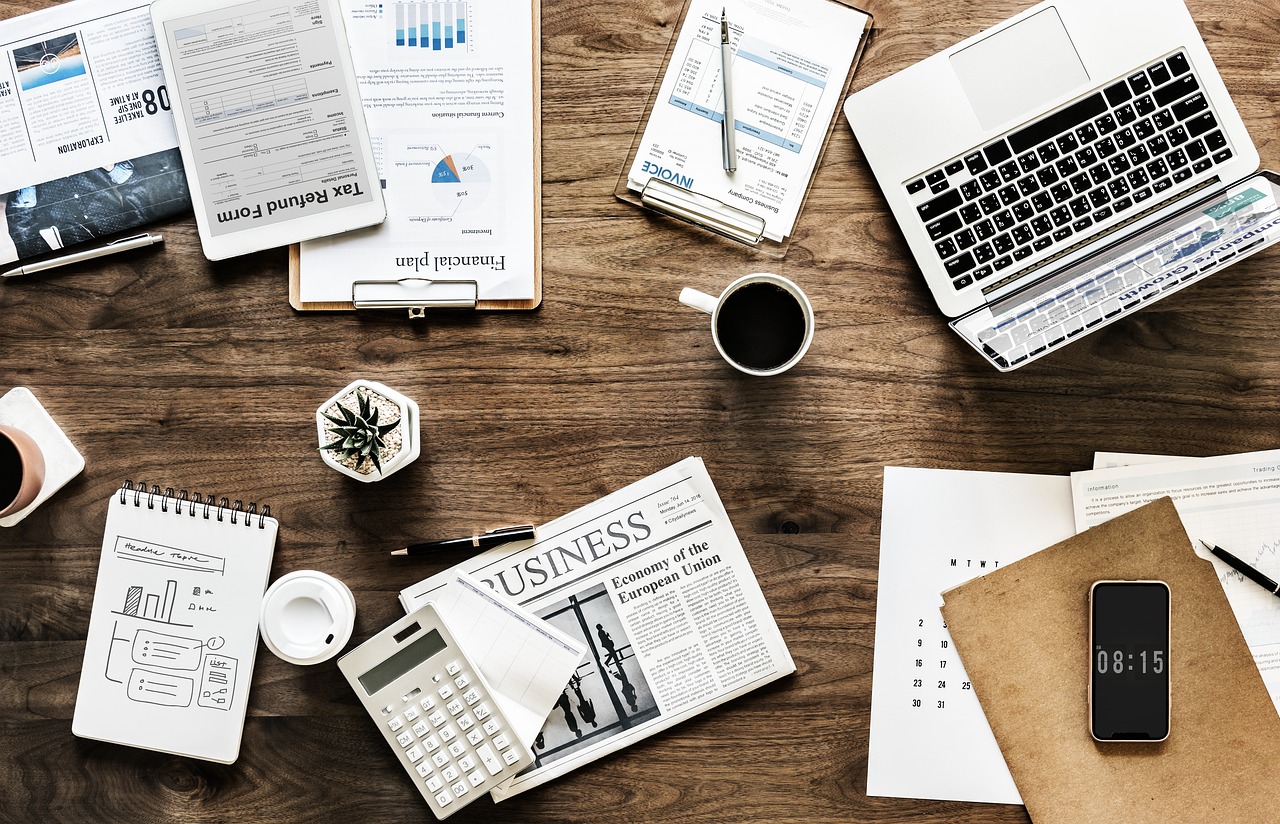 A business professional reviewing financial and performance data at a desk, tracking whether an AI initiative is delivering measurable ROI