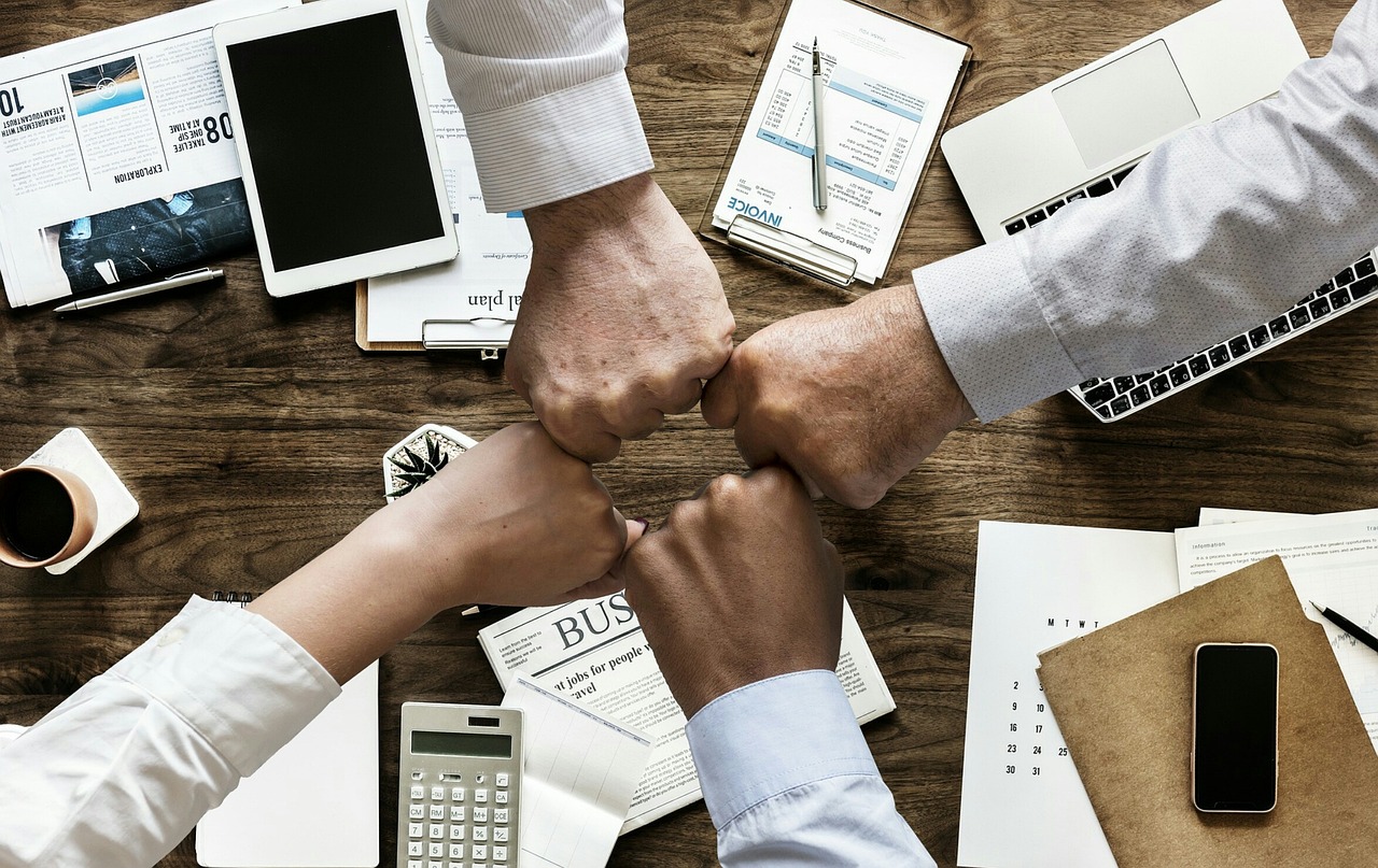 A small business team gathered around a table in a brainstorming session, mapping out an AI project plan