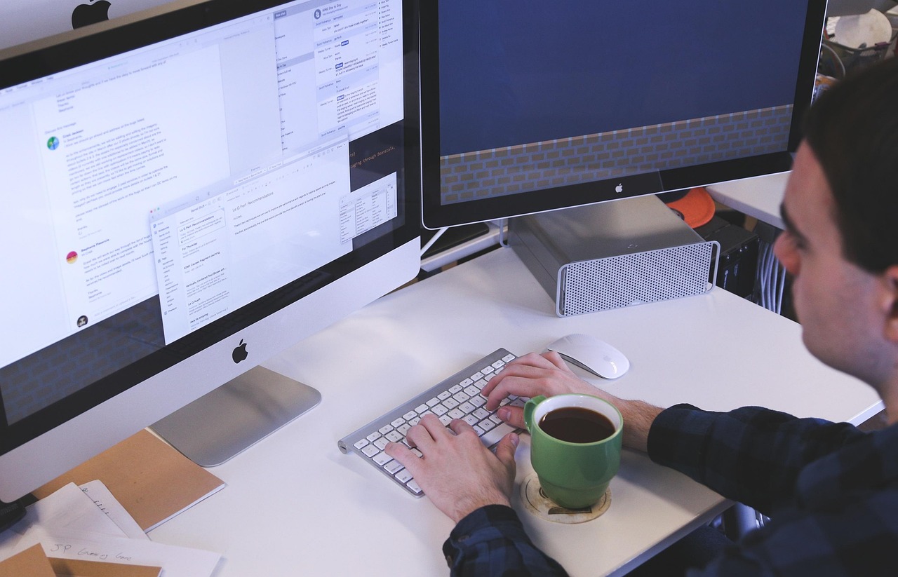 A person's hands typing on a laptop keyboard, representing the repetitive data entry work computer-use agents are built to take over