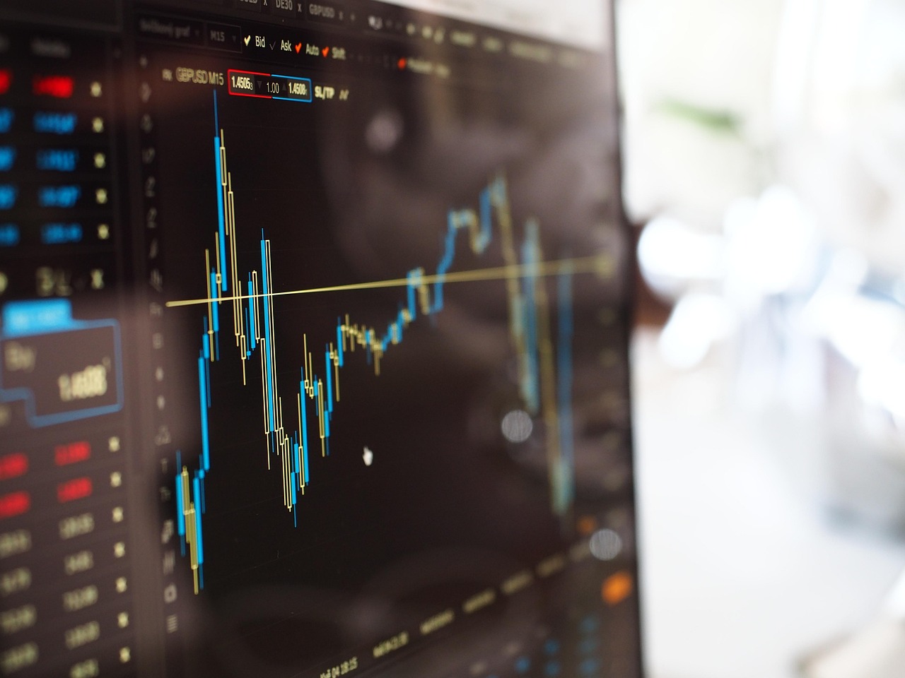 A blurred financial chart glowing on a dark computer screen, symbolizing volatile and rising AI spending