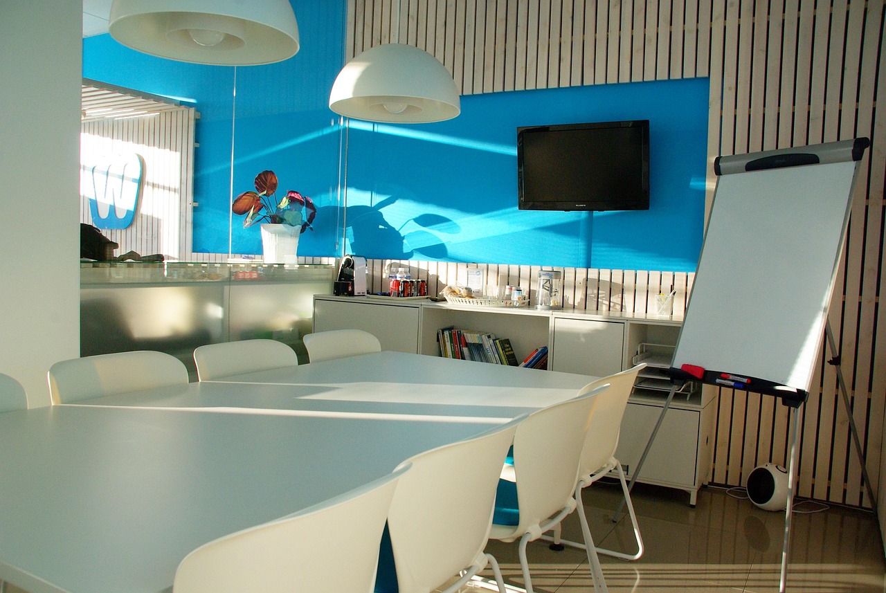 A bright open-plan startup office with people working at long desks, representing Calgary's expanding base of technology companies
