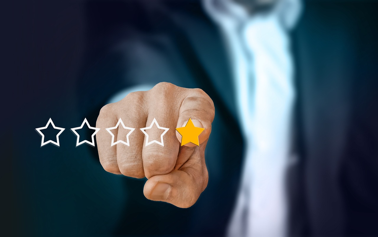 Customer feedback and star-rating icons overlaid on a laptop screen, representing online review and reputation management