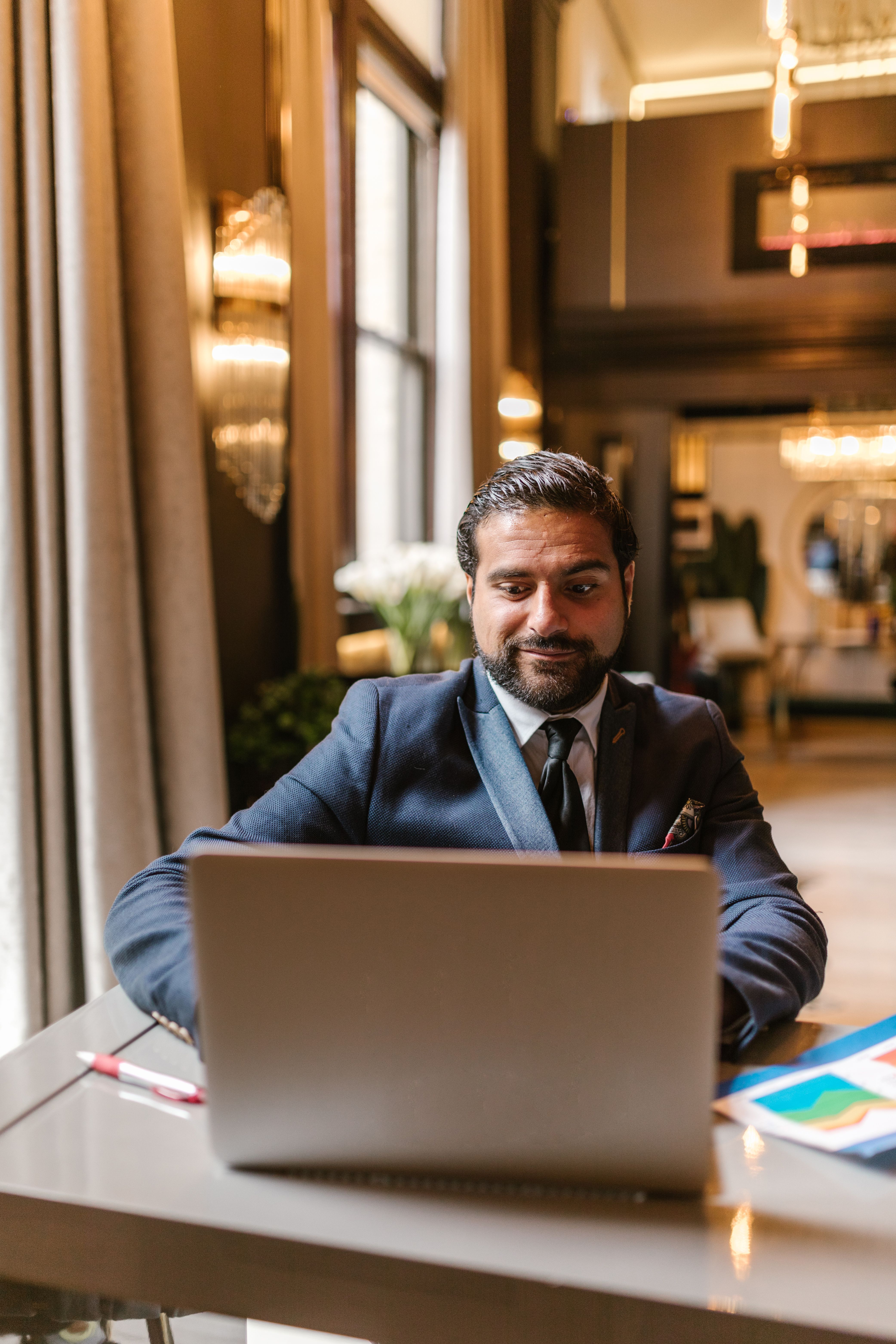 Small business owner working on a laptop at an office desk, checking website traffic after Google AI Overviews changed search results